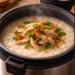 Resep bubur ayam rice cooker yang lembut dan praktis untuk pemulihan pencernaan pasca-mudik.
