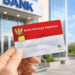 Seseorang menunjukkan kartu KKS baru setelah melakukan proses pengurusan kartu yang hilang di bank.