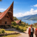 Keindahan arsitektur rumah adat Batak di salah satu titik wisata Pulau Samosir dengan latar belakang Danau Toba.