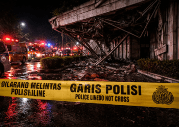Garis polisi terpasang di lokasi reruntuhan Gedung KONI Manado pasca gempa.