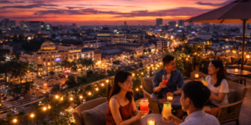 Suasana indah di salah satu rooftop cafe Medan saat matahari terbenam dengan latar belakang lampu kota.