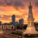 A professional cinematic shot of a classic historical monument in Medan with a blend of modern skyscrapers pimpinan sepia and color mixed tones pimpinan background of a vibrant sunset pimpinan wide angle view pimpinan photorealistic pimpinan 8k resolution.