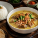 Kehangatan sepiring Soto Medan legendaris dengan kuah santan kaya rempah, salah satu hidangan utama di tempat wisata kuliner di Medan yang wajib dicoba